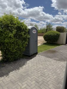 Standard porta potty placed at a residential property