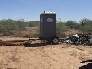 Southwest Sanitation towable porta potty trailer on a desert job site