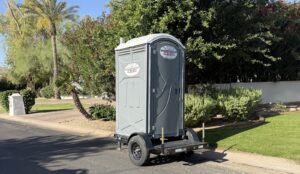 Southwest Sanitation towable porta potty trailer parked on a residential street