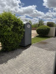 Standard porta potty placed at a residential property
